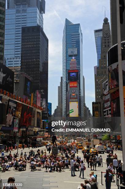 People make their way through Times Square, the famous stretch of Manhattan's Broadway Avenue between 47th Street and 42nd Street, before work starts...