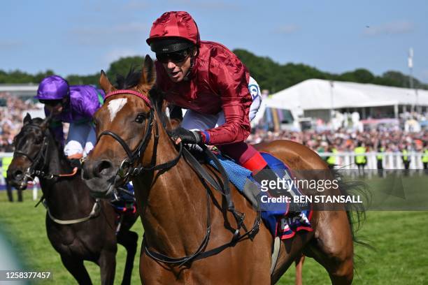 Jockey Frankie Dettori rides Soul Sister to victory in the Oaks on the first day of the Epsom Derby Festival horse racing event in Surrey, southern...