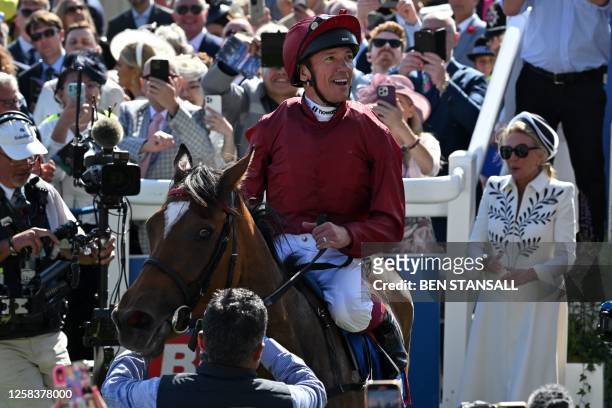 Jockey Frankie Dettori and Soul Sister enter the winner's enclosure after victory in the Oaks on the first day of the Epsom Derby Festival horse...