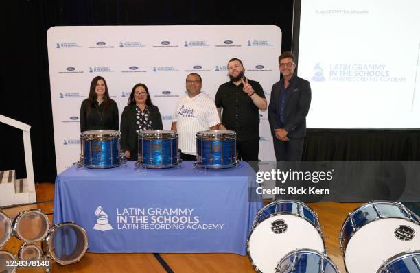 El Fantasma and Francisco "Paco" Fuentes pose with faculty at the Latin GRAMMY In The Schools educational program at Sidney Lanier High School on May...