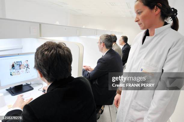 People take part in a sensory test by drinking several orange juices in the newly inaugurated headquarters of Biofortis, subsidiary French...