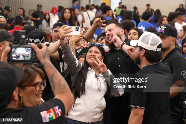 El Fantasma poses with students at the Latin GRAMMY In The Schools educational program at Sidney Lanier High School on May 24, 2023 in San Antonio,...