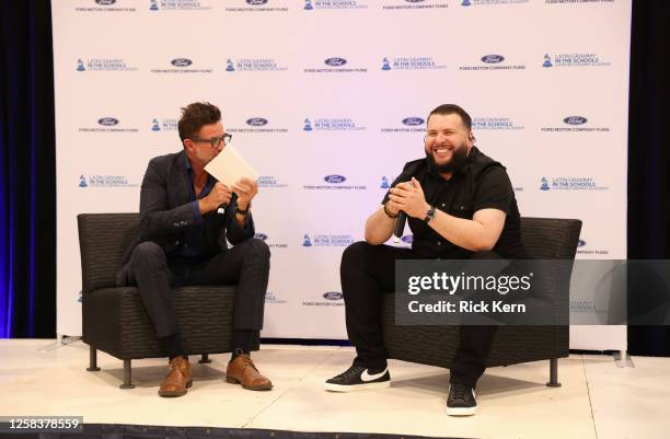 Francisco "Paco" Fuentes and El Fantasma speak onstage at the Latin GRAMMY In The Schools educational program at Sidney Lanier High School on May 24,...