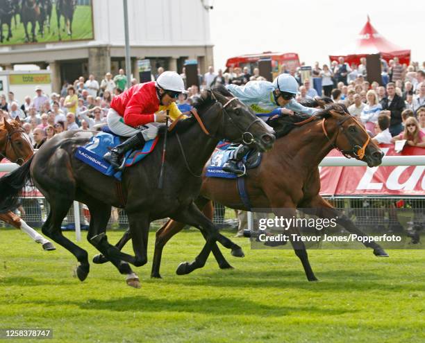 Irish Jockey Eddie Ahern riding Elusive Pimpernel winning the Acomb Stakes at York, 18th August 2009. Placed second Irish Jockey Richard Hughes...