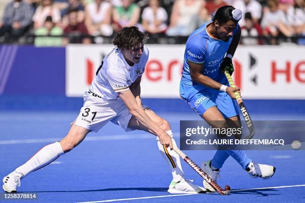 Belgium's Arnaud Van Dessel and India's Dilpreet Singh fight for the ball during a game between Belgium's Red Lions and India, the third match in the...