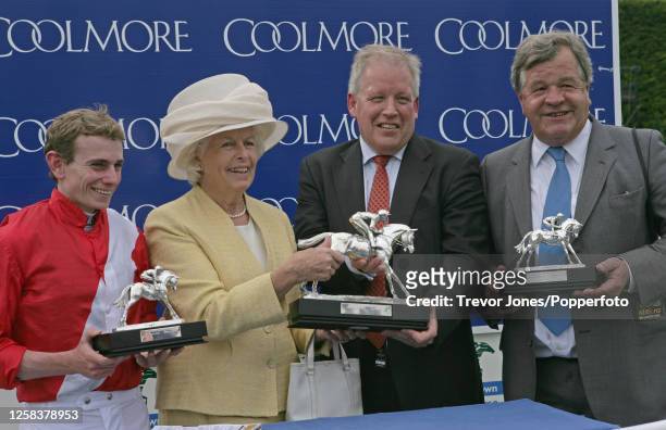 Evie Stockwell representing Coolmore presenting the trophies to Jockey Ryan Moore, John Marsh Senior Manager of owner breeder Cheveley Park Stud and...