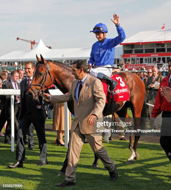 Trainer Mahmood Al Zarooni leading in French Jockey Mickael Barzalona after winning the St Leger at Doncaster, 15th September 2012.