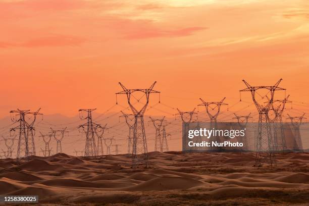 An ultra-high voltage direct current power transmission project is seen on grassland in Ordos city, Inner Mongolia, China, June 1, 2023. The 800 kV...