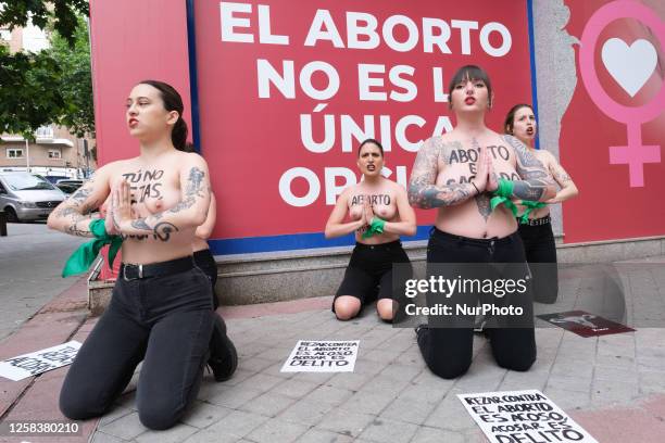 Image contains nudity.) Activists of feminist group FEMEN with their bare chests painted with messages reading ''You don't pray, you harass'' and...