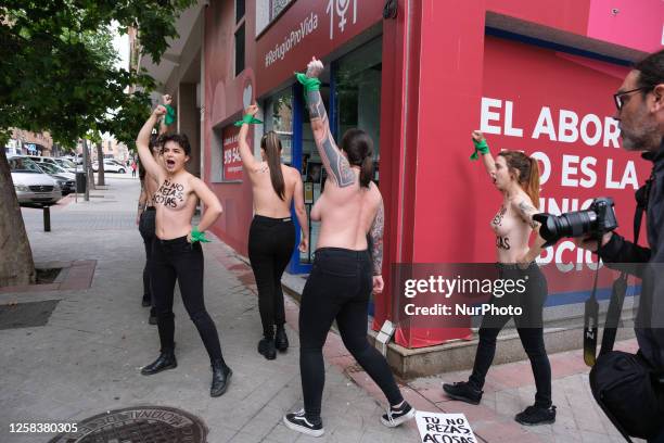 Image contains nudity.) Activists of feminist group FEMEN with their bare chests painted with messages reading ''You don't pray, you harass'' and...