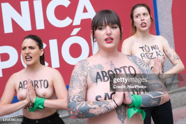 Image contains nudity.) Activists of feminist group FEMEN with their bare chests painted with messages reading ''You don't pray, you harass'' and...