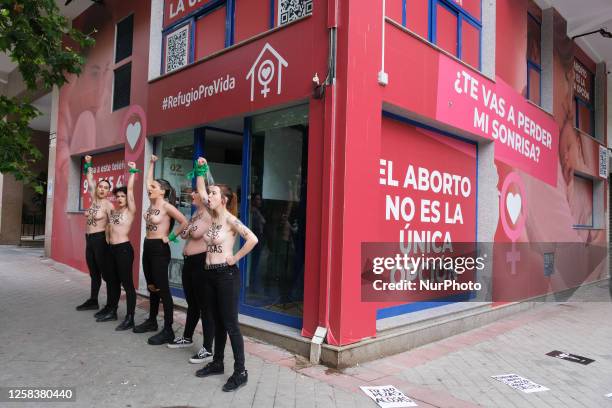 Image contains nudity.) Activists of feminist group FEMEN with their bare chests painted with messages reading ''You don't pray, you harass'' and...