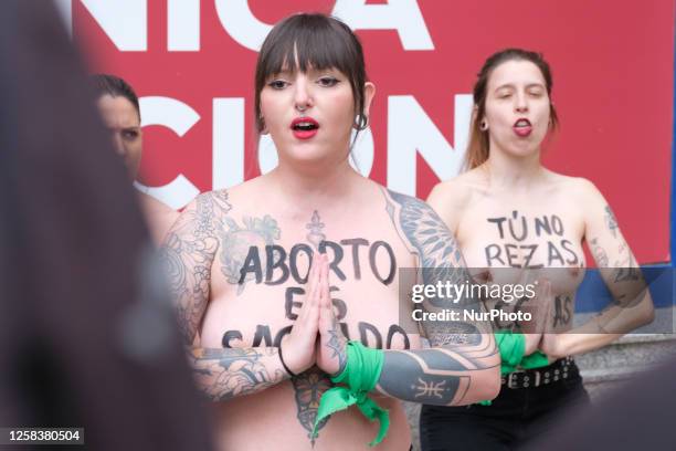 Image contains nudity.) Activists of feminist group FEMEN with their bare chests painted with messages reading ''You don't pray, you harass'' and...