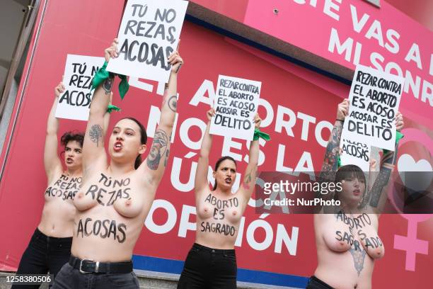 Image contains nudity.) Activists of feminist group FEMEN with their bare chests painted with messages reading ''You don't pray, you harass'' and...