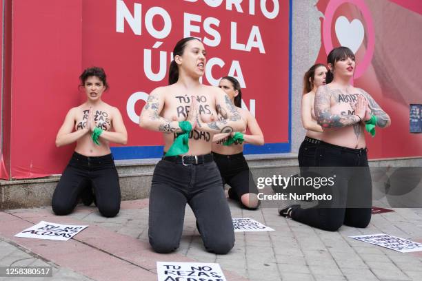 Image contains nudity.) Activists of feminist group FEMEN with their bare chests painted with messages reading ''You don't pray, you harass'' and...