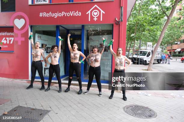 Image contains nudity.) Activists of feminist group FEMEN with their bare chests painted with messages reading ''You don't pray, you harass'' and...