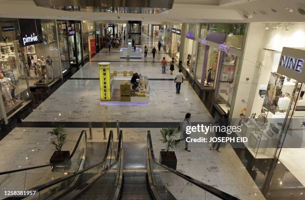 Bahrainis walk at a mall in central Manama on March 22, 2011 as pro-democracy protests in Bahrain began on February 14 and Bahraini security forces...