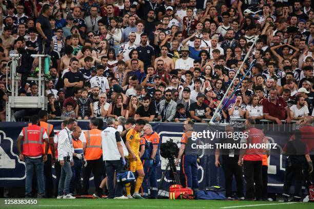 Rodez' French midfielder Lucas Buades walks off the pitch after being hit by a projectile during the French L2 football match between FC Girondins de...