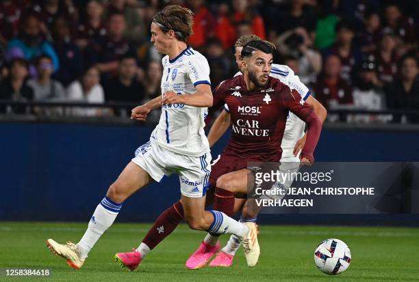 Bastia's French midfielder Tom Ducrocq fights for the ball with Metz's Georgian forward Georges Mikautadze during the French L2 football match...