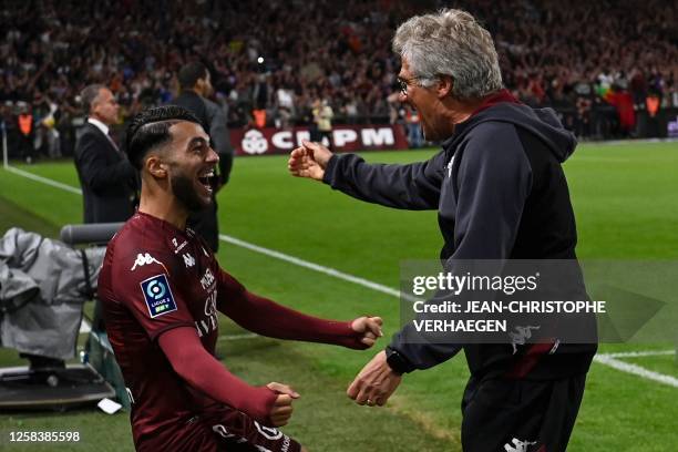 Metz's Georgian forward Georges Mikautadze celebrates with Metz's Romanian head coach Laszlo Boloni at the end of the French L2 football match...