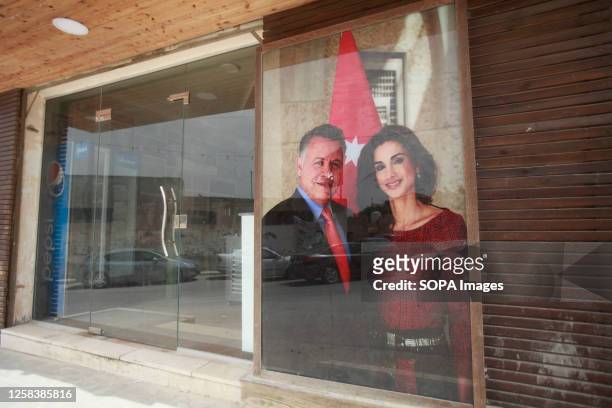 View of a poster of King Abdullah II of Jordan and his wife Queen Rania on a Palestinian store, during the occasion of their son Prince Hussein's...