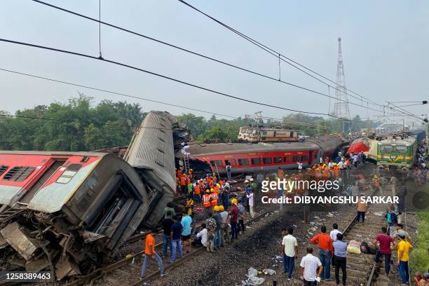 Rescue workers search for survivors at the accident site of a three-train collision near Balasore, about 200 km from the state capital Bhubaneswar,...