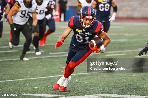 Montreal Alouettes wide receiver Austin Mack runs the ball during the Hamilton Tiger-Cats versus the Montreal Alouettes preseason game on June 02 at...