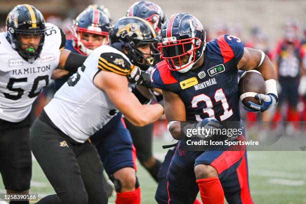 Montreal Alouettes running back William Stanback runs the ball during the Hamilton Tiger-Cats versus the Montreal Alouettes preseason game on June 02...