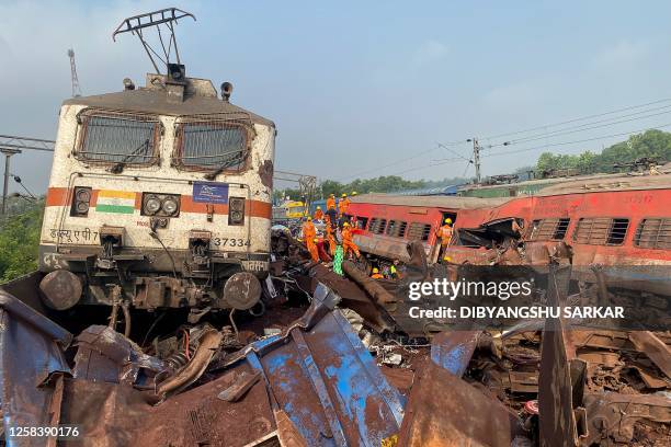 Damaged carriages are seen at the accident site of a three-train collision near Balasore, about 200 km from the state capital Bhubaneswar, on June 3,...