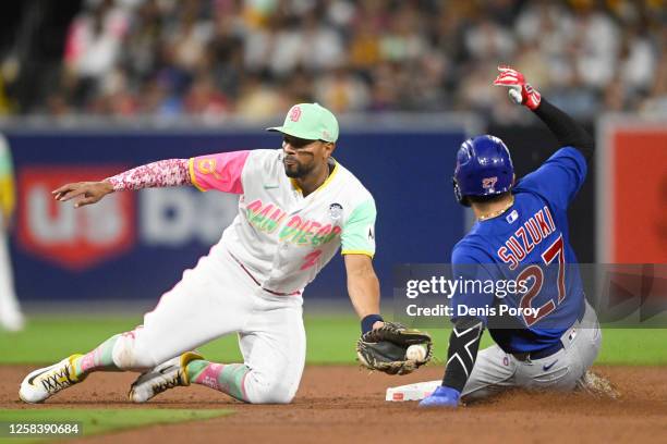Seiya Suzuki of the Chicago Cubs is tagged out by Xander Bogaerts of the San Diego Padres as he tries to steal second base during the fifth inning of...