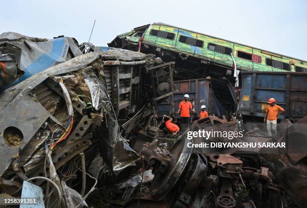 Rescue workers sift through wreckage at the accident site of a three-train collision near Balasore, about 200 km from the state capital Bhubaneswar...