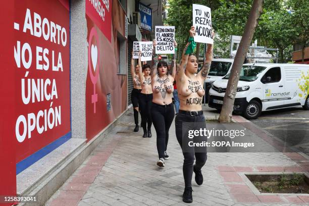 Group of activists from the feminist movement Femen hold placards during the anti-abortion protest in front of "Pro-Life Shelter" to denounce the...