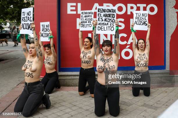 Group of activists from the feminist movement Femen hold placards during the anti-abortion protest in front of "Pro-Life Shelter" to denounce the...