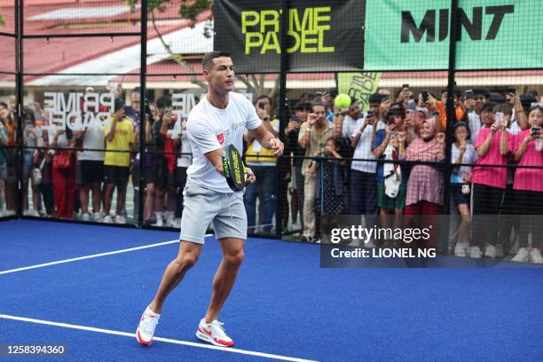 Portuguese football player Cristiano Ronaldo hits a padel ball during an event to support youth scholarships founded by philanthropist Peter Lim in...