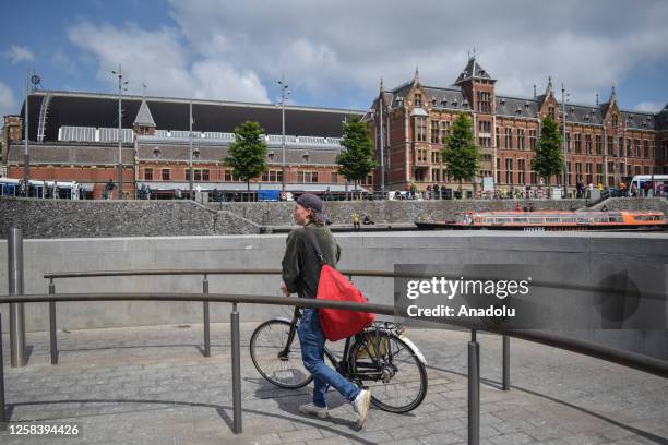 Man with a bicycle walks during World Bicycle Day in Utrecht, Netherlands on June 2, 2023. World Bicycle Day, declared by the United Nations in April...