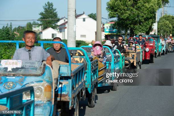 Local villagers line up to sell wheat at a grain purchase warehouse at Hai 'an Farm in East China's Jiangsu province, June 3, 2023.