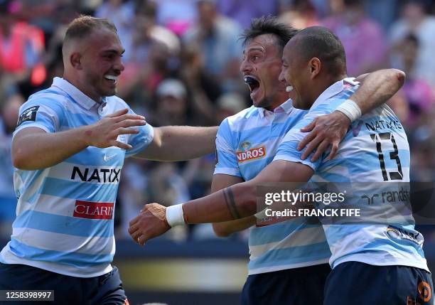 Racing 92's French wing Gael Fickou is congratulated by teammates after scoring a try during the French Top 14 playoff rugby union match between...