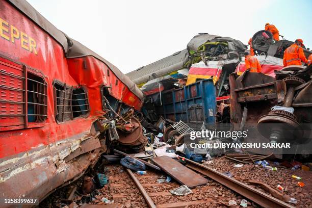 Graphic content / Rescue workers recover victims' bodies from a carriage wreckage of a three-train collision near Balasore, in India's eastern state...