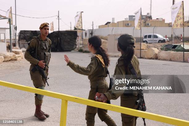 Israeli soldiers are pictured outside the Mount Harif military base near the city of Mitzpe Ramon in Israel's southern Negev desert, adjacent to the...