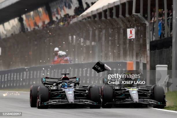 Mercedes' British driver George Russell and Mercedes' British driver Lewis Hamilton compete during the qualifying session for the Spanish Formula One...