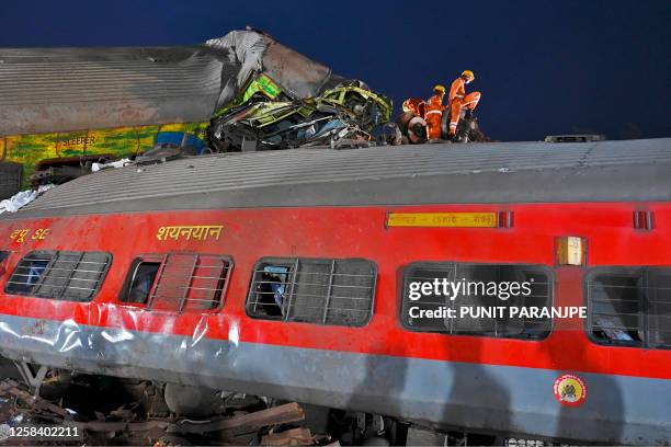 Graphic content / Rescue workers recover victims' bodies from the carriage wreckage of a three-train collision near Balasore, in India's eastern...
