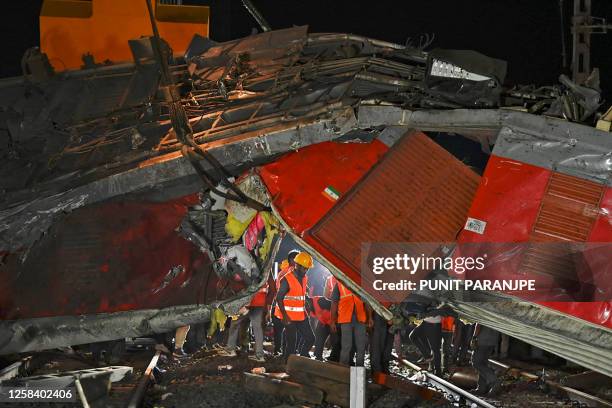 Graphic content / Rescue workers recover victims' bodies from the carriage wreckage of a three-train collision near Balasore, in India's eastern...