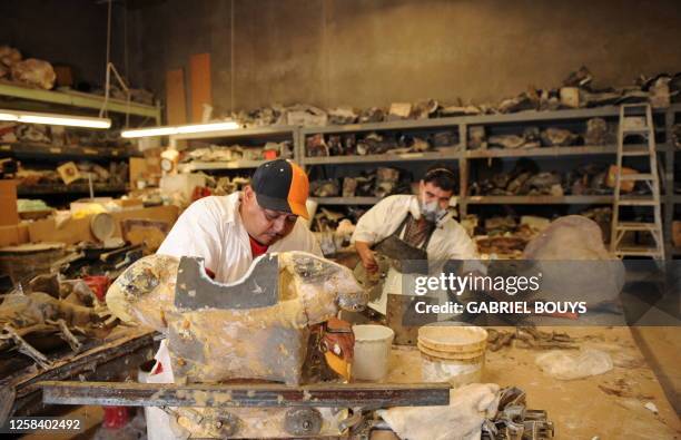 Men work on a mannequin at Patina V in City of Industry, California, on September 29, 2009. Patina V is a company providing mannequins for store...