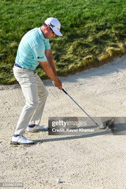 Zach Johnson plays a shot from a greenside bunker on the 18th hole during the second round of the Memorial Tournament presented by Workday at...