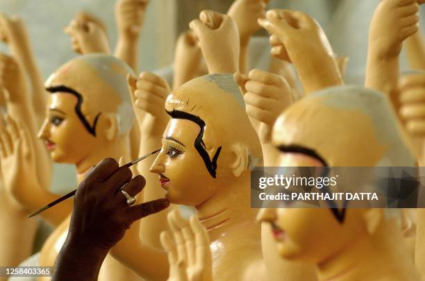 An Indian artist gives finishing touches to a statue of Hindu God Biswakarma in Agartala, 09 September 2007. Biswakarma, or Vishkarma, was the...