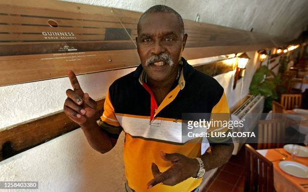 Cuban Havana cigar manufacturer, Jose "Cueto" Castelar, shows his 20,41 metres long and 4 centimetres wide cigar at the restaurant of the...