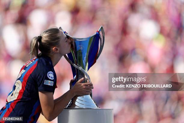 Barcelona's Swedish forward Fridolina Rolfo kisses the trophy on the podium after her team's victory in the UEFA Women's Champions League final...