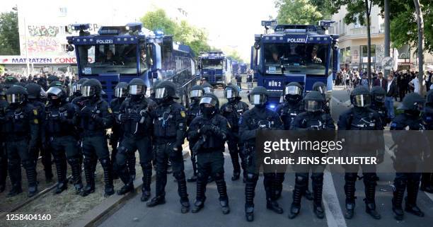 Policemen stand in front of their water cannons during a so-called "national day of action" organised by far-left activists on June 3, 2023 in...