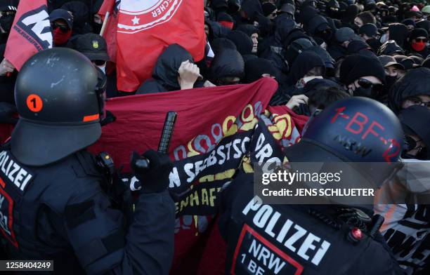 Policemen face demonstrators during a so-called "national day of action" organised by far-left activists on June 3, 2023 in Leipzig, eastern Germany,...