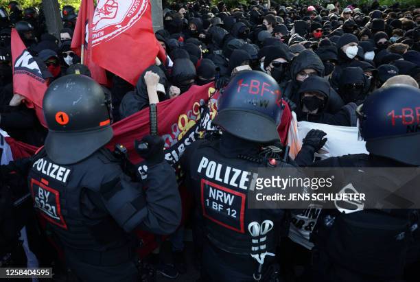 Policemen face demonstrators during a so-called "national day of action" organised by far-left activists on June 3, 2023 in Leipzig, eastern Germany,...